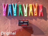 Multi-colored clothespins, battery Kodak, water, original photo